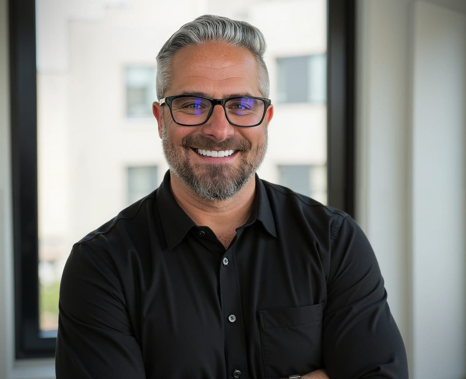 Damien Komala smiling in a studio portrait
