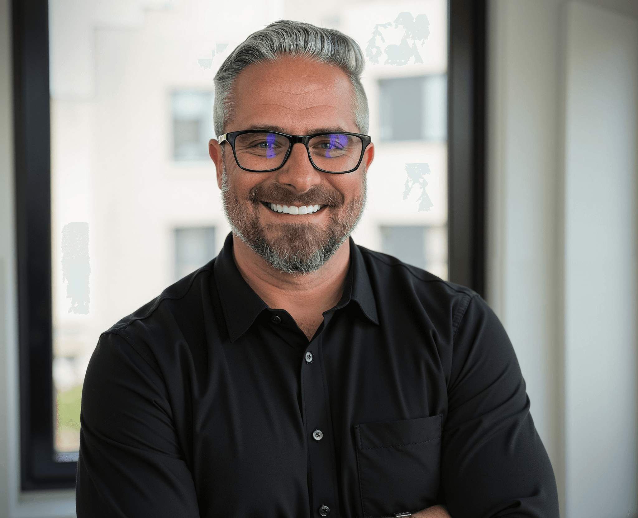 Damien Komala smiling in a studio portrait